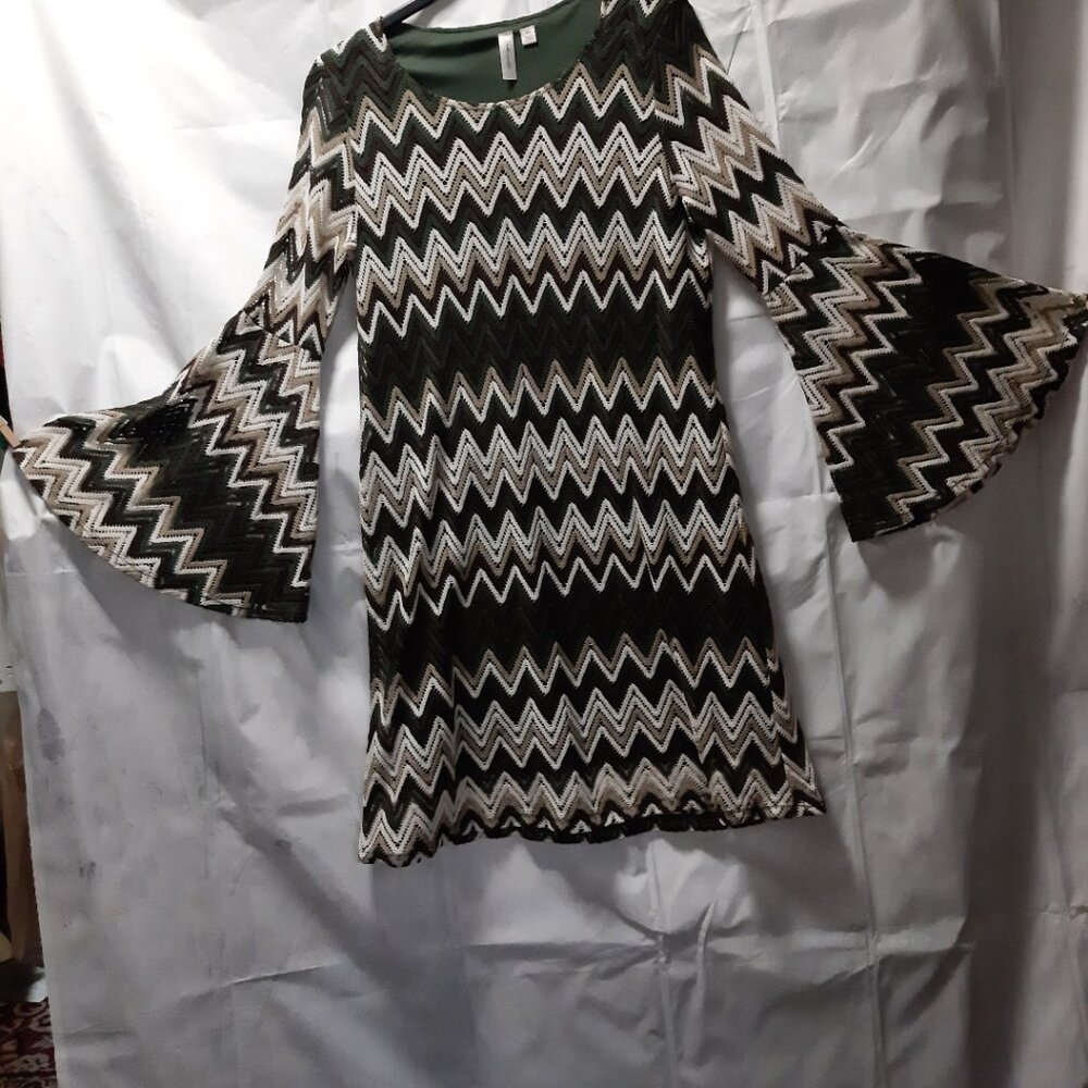 Elegant  chevron-patterned sheath dress featuring statement bell sleeves
